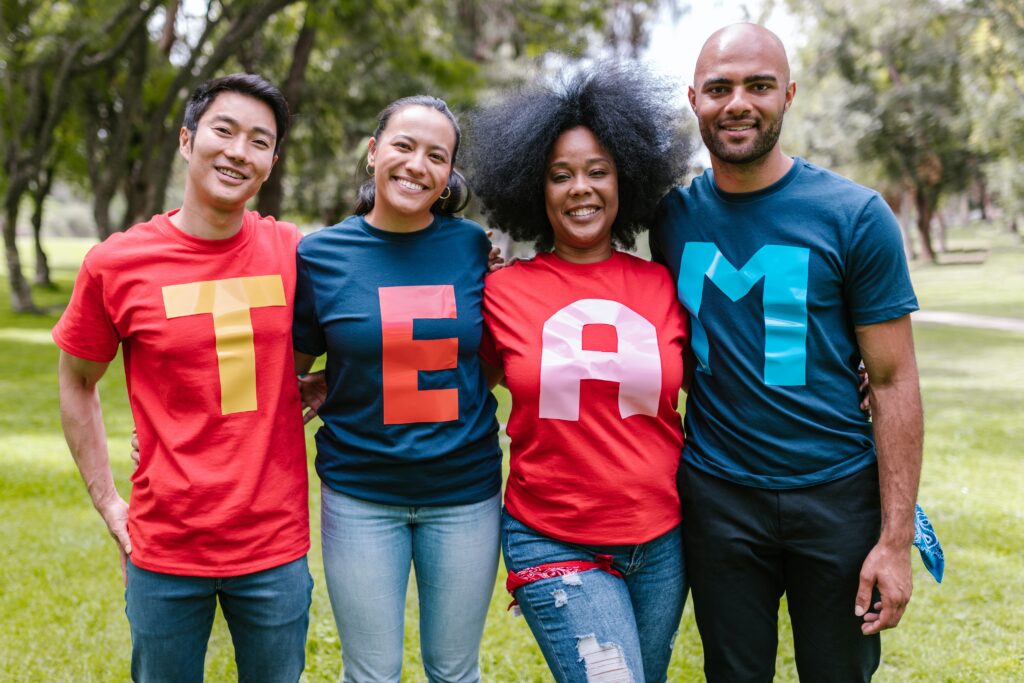 A group of individuals with the word team spelled out on their shirts to indicate a high-performance group of people.